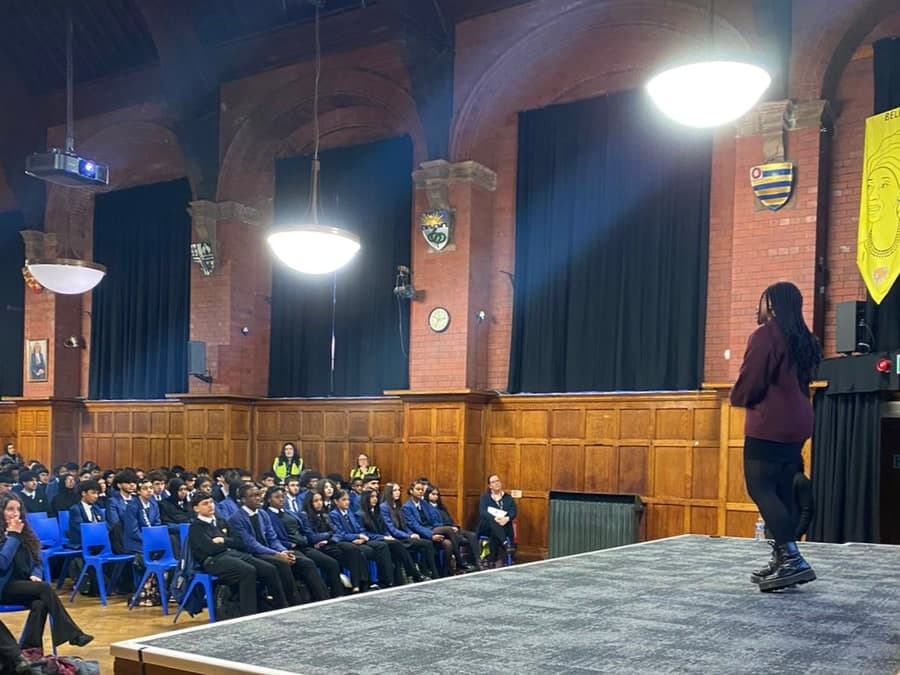 LACE Network speaker addressing a school assembly